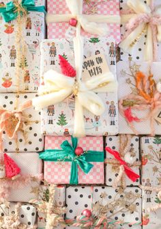 many wrapped presents with bows on them