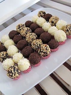 a white plate topped with chocolate covered cupcakes