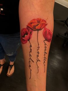 a woman's leg with red flowers on it and the words, i love you