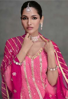 Dual Shade Pink Georgette Sharara Set with Embroidered Net Dupatta - XL Size Ready to ship USA Dress has V Neck and Bell Sleeve attire is Enhanced with Zari, Sequins and Stone Work. Available with Georgette Palazzo in Shaded Pink and Fuchsia and a Net Dupatta in Shaded Pink and FuchsiaThe Kameez and Bottom Lengths are 42 and 40 inches respectively Description: Elevate your ethnic wardrobe with our stunning Dual Shade Pink Georgette Sharara Set. Crafted with meticulous attention to detail, this X Palazzo Set With Dupatta For Celebration, Kundan Sets For Navratri, Celebration Sets With Cutdana, Sharara With Dupatta For Celebration, Pink Straight Kurta Palazzo Set For Celebrations, Celebration Pink Palazzo Set With Resham Embroidery, Pink Palazzo Set With Traditional Drape For Celebrations, Traditional Drape Pink Palazzo Set For Celebration, Traditional Pink Palazzo Set For Celebration