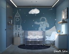 a baby's room decorated in blue and white with an astronaut mural on the wall