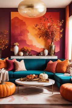 Step into this vibrant living room, where Ombre wall decor bathes the space in the hues of a twilight sky. The stunning transition from regal purple to fiery orange is adorned with autumn wall art that whispers of falling leaves. A plush teal sofa beckons, strewn with colorful pillows. A white coffee table takes center stage, surrounded by playful pumpkins. The hanging pendant light, reminiscent of the harvest moon, casts a warm glow. Orange And Purple Living Room Decor, Blue Sofa Orange, Teal And White Living Room Ideas, Sunset Living Room Decor, Orange Maximalist Living Room, Orange Teal Living Room, Blue And Orange Living Room Color Scheme, Living Room With Teal Sofa, Teal Blue Sofa Living Room Ideas