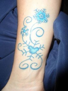 a person with a tattoo on their arm that has snowflakes all over it