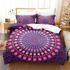 a purple and pink comforter set on a bed