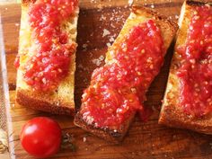 three pieces of bread with tomato sauce on them