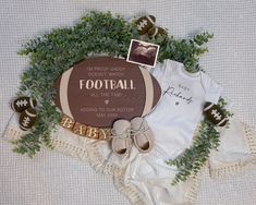 a baby's football themed outfit and booties on a blanket