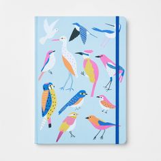 a notebook with colorful birds on the front and blue cover, sitting on top of a white surface