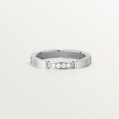 a white gold ring with five diamonds