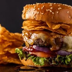 a hamburger and some potato chips on a table