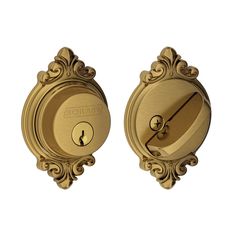 the door knobs are gold and have ornate designs on them, as well as a keyhole