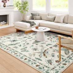 a living room filled with furniture and a large rug on top of a hard wood floor