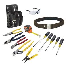 tools are laid out on a white background including safety glasses, belt and other items