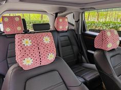 the interior of a car with pink crocheted flowers