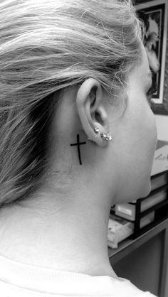 a woman with a cross behind her ear