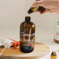 a person is holding a bottle with cleaning spray on it