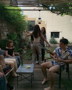 a group of people sitting on top of a wooden deck