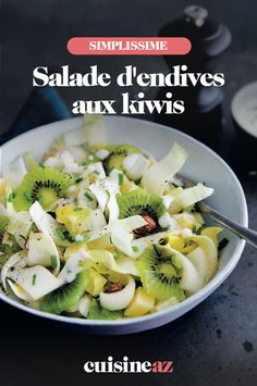 a white bowl filled with sliced kiwis on top of a black countertop