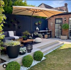 an outdoor living area with patio furniture and plants