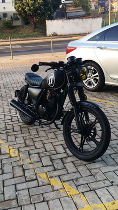 a black motorcycle parked on the side of a road