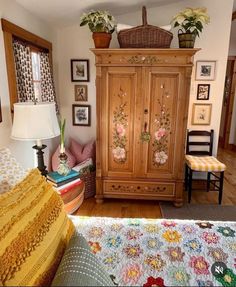 a bedroom with a bed, dresser and pictures on the wall