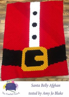 a crocheted santa clause blanket with the letter c on it