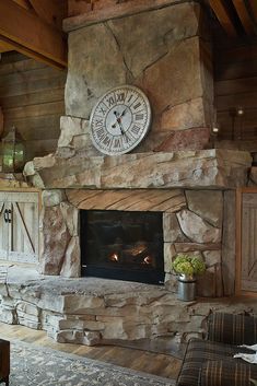 a stone fireplace with a clock above it