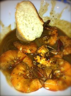 a white plate topped with shrimp and bread