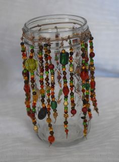 a glass jar filled with lots of beads