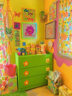 a child's room decorated in bright colors with lots of pictures on the wall