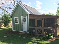 a small green shed with a white door