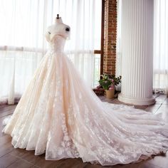 a wedding dress on display in front of a window