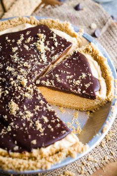 there is a chocolate pie on the plate with one slice cut out and ready to be eaten