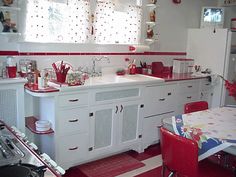 a red and white kitchen with lots of counter space