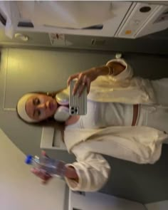 a woman in an airplane holding a water bottle