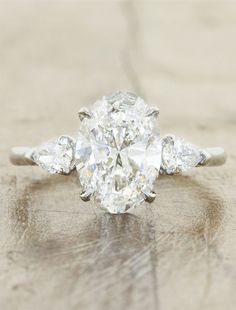 an oval diamond ring with three pear shaped diamonds