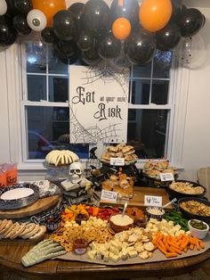 a table filled with lots of food and balloons