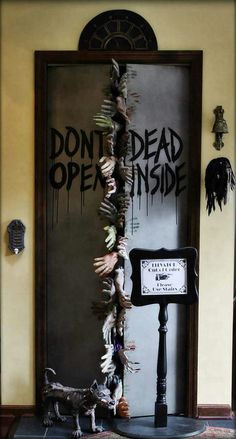 the door is decorated with fake dead hands and bones hanging from it's sides