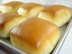 four loaves of bread sitting on top of a pan