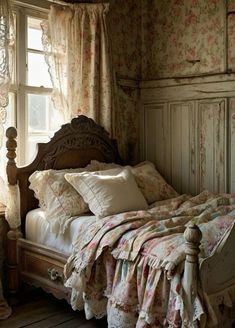 an old fashioned bed in a bedroom with floral wallpaper and curtains on the windowsill