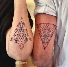 two people with matching tattoos on their legs, one is holding the other's leg