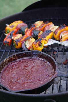 some food is cooking on a grill with tongs