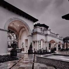 an outdoor courtyard with fountains and potted plants