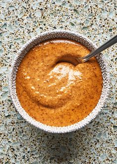 a bowl filled with peanut butter on top of a table