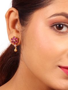 Crafted from 925 silver with a polished gold finish, this earring showcases an elegant and minimalistic Rosana stud (rose) design. It is adorned with vibrant red kemp and white kundan stones, accompanied by enchanting ball dangles that enhance its delightful and beautiful appeal. Ideal for daily wear, the Rosana stud adds a charming touch to your everyday attire. Please refer to the pictures of the jewelry worn on a model to get a clear idea of the size. Condition: New. This product is intricately designed and meticulously handcrafted with exceptional care by our skilled silversmiths, employing traditional Indian techniques. Every jewelry piece from Sashastrends bears a 925-hallmark stamp! Earring closure: Screw back. Material: 925 silver (gold polish), red kemp, white kundan stones. Place Stone Stud Earrings, Stamped Earrings, Silver Wedding Jewelry, San Ramon, 925 Silver Earrings, Christmas Gift Jewelry, 925 Silver Jewelry, Gold Polish, Silver Gifts