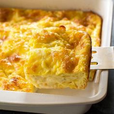 a close up of a piece of food on a fork in a casserole dish