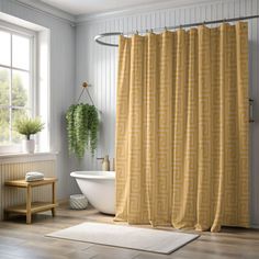 a bathroom with a bathtub, sink and shower curtain in yellow color on the wall