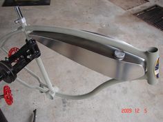 the handlebars and seat are attached to the front wheel of a bicycle in a garage