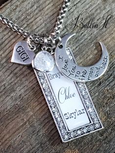 "Beautiful gift that any Grandma, Mom, Gigi, Mimi, Nana, Aunt, etc. is sure to treasure. The pendant can come with up to 11 names, and measures 1 7/8\" x 7/8\"; and is outlined in rhinestones that SPARKLE beautifully. If you are choosing up to 5 names, they will come in varying fonts as shown in the primary sample photo. If choosing more than 5 names, they will all be in the print font. The link chain is silver plated and is only available in 18\". The item is accented with a cracked glass penda Customized White Charm Necklace For Gift, Customized White Charm Necklaces For Gift, White Charm Necklace For Valentine's Day Birthday Gift, White Charm Necklace For Birthday On Valentine's Day, Personalized White Charm Necklace For Valentine's Day, Personalized White Charm Necklaces For Valentine's Day, Valentine's Day Personalized White Charm Necklace, White Jewelry Gift For Father's Day, White Jewelry For Father's Day Gift