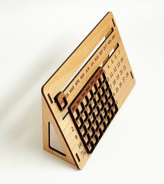 a wooden calculator that is shaped like an old computer key board with numbers on it