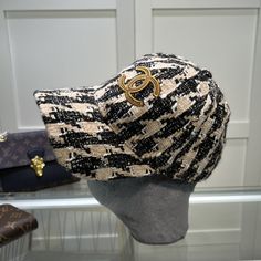 SHOP MORE LUXURY PRODUCTS HERE Description Chanel Hat Black/Beige Hat with Chanel brand with dynamic and youthful design Black/BeigeBlack/Beige FabricChanel Logo Includes box, dust bag.This product is of the premium quality. Cc Hats, Chanel Hat, Dior Shirt, Gucci Shirt, Louis Vuitton Shirt, Beige Hat, Chanel Shirt, Chanel Brand, Chanel Logo